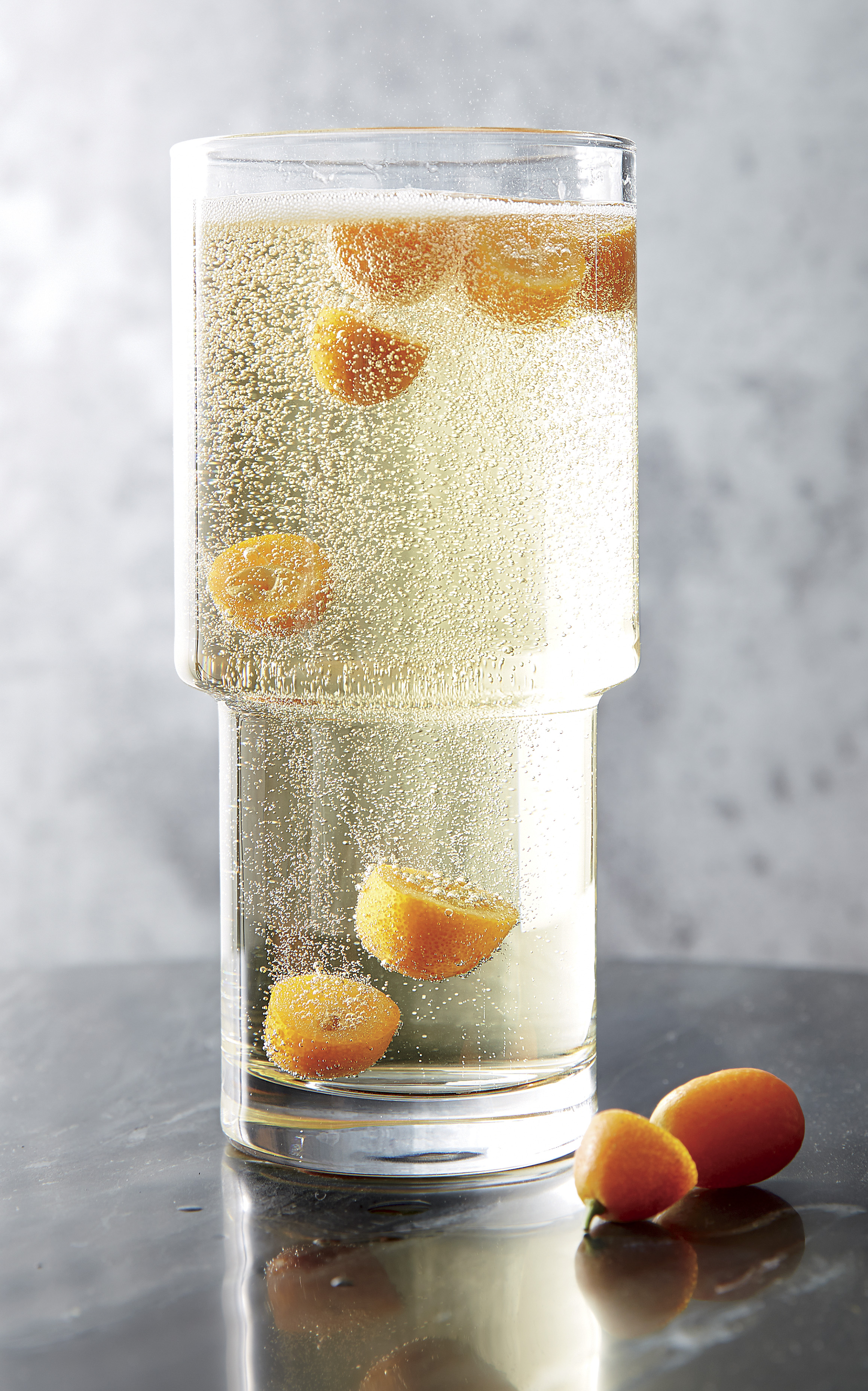 Crate & Barrel champagne cocktail with kumquats